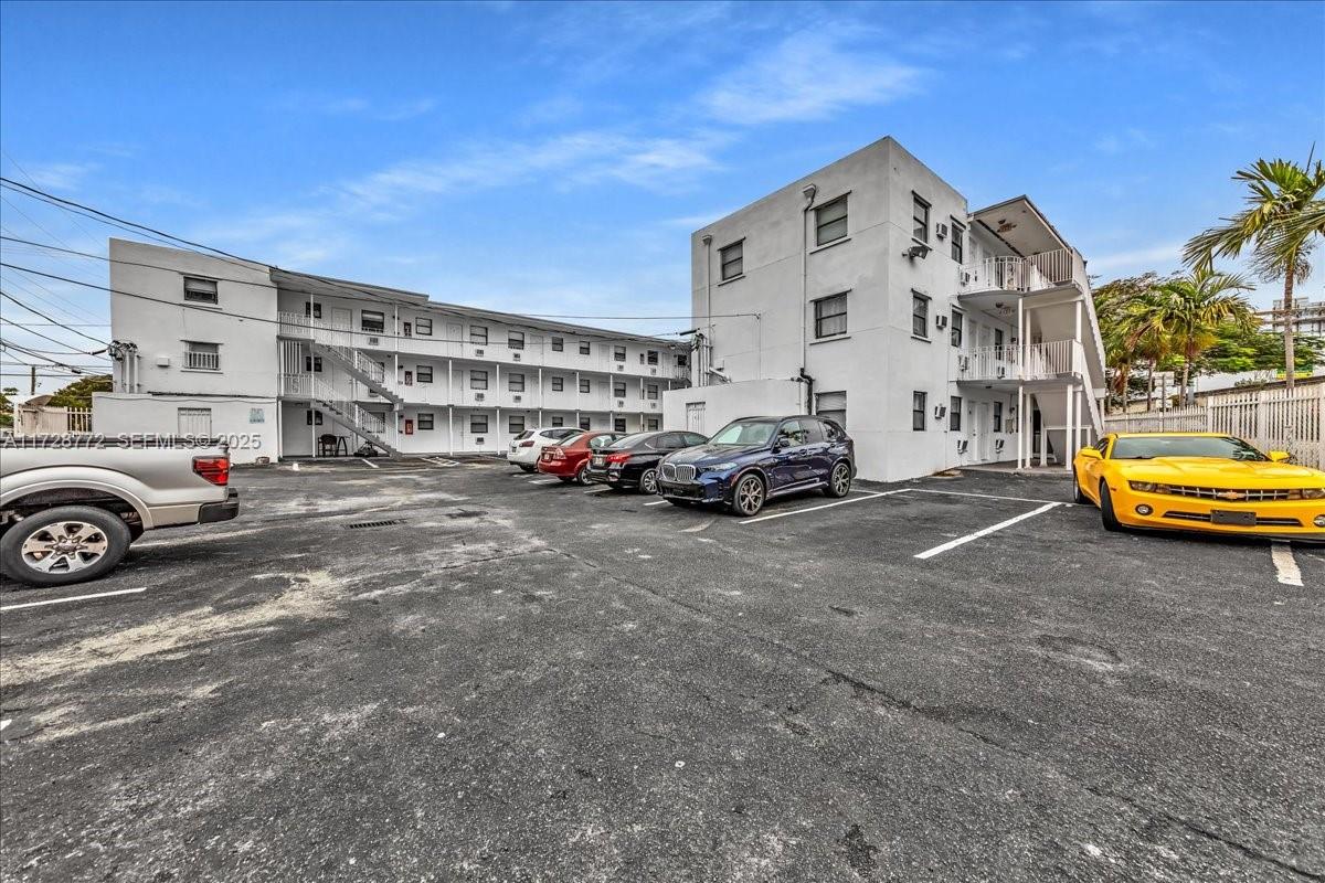 365 Northwest 8th Street, Unit 211 Miami, FL 33136 - Photo 23 of 29 a view of building with cars parked in front of it