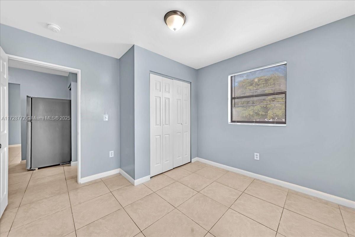365 Northwest 8th Street, Unit 211 Miami, FL 33136 - Photo 9 of 29 a view of an empty room with window and cabinet