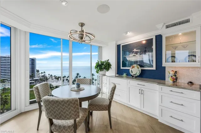 a kitchen with a table chairs stove and cabinets