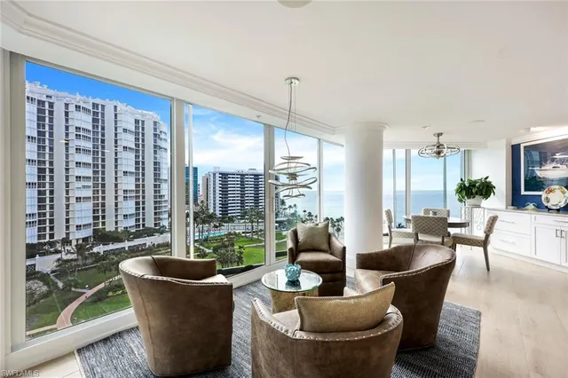 a living room with furniture a large window and a fountain