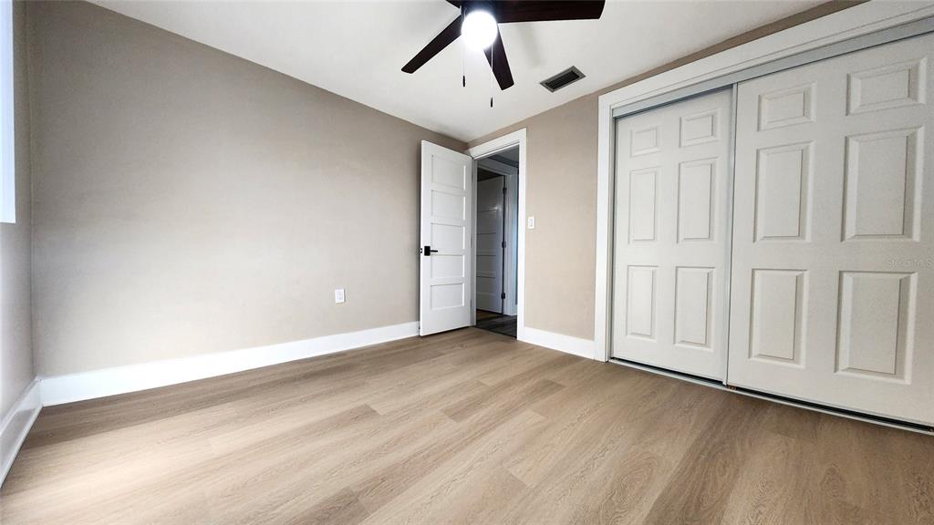 3629 Bedford Street New Port Richey, FL 34652 - Photo 12 of 29 an empty room with wooden floor and windows