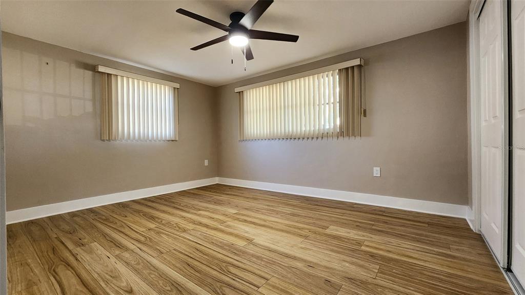 3629 Bedford Street New Port Richey, FL 34652 - Photo 16 of 29 a view of an empty room with wooden floor and a window
