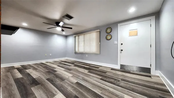 a view of a livingroom with a ceiling fan and window