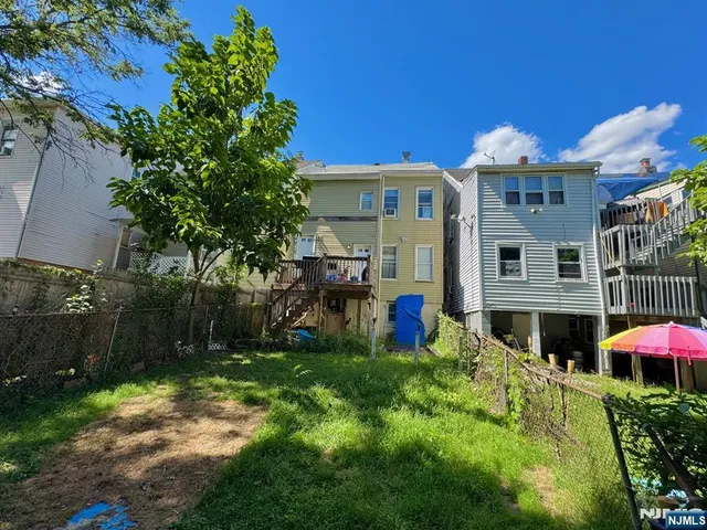a view of a house with pool and chairs