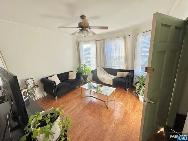 a living room with furniture and a chandelier