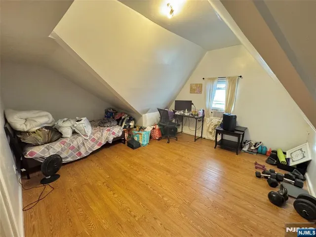 a bedroom with furniture and a wooden floor