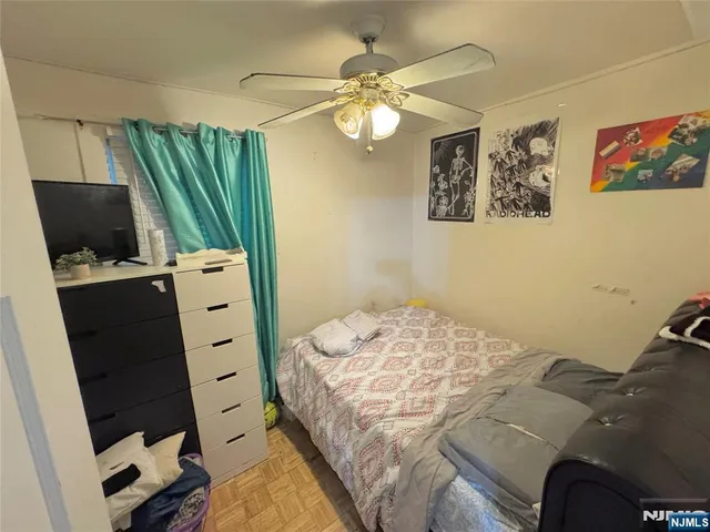 a bedroom with a bed and a television