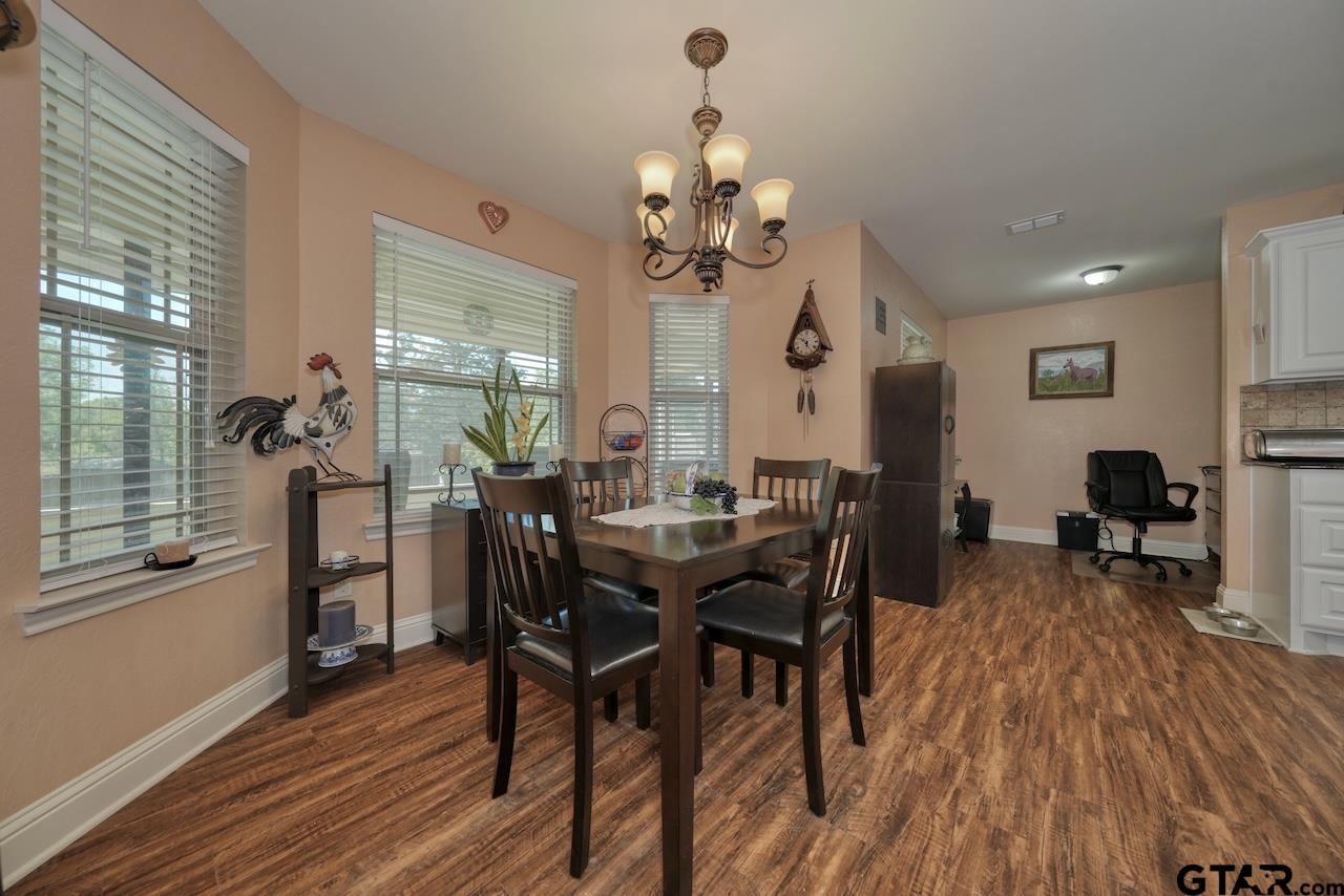 412 Elm Lane Lindale, TX 75771 - Photo 11 of 48 a view of a dining room with furniture and wooden floor