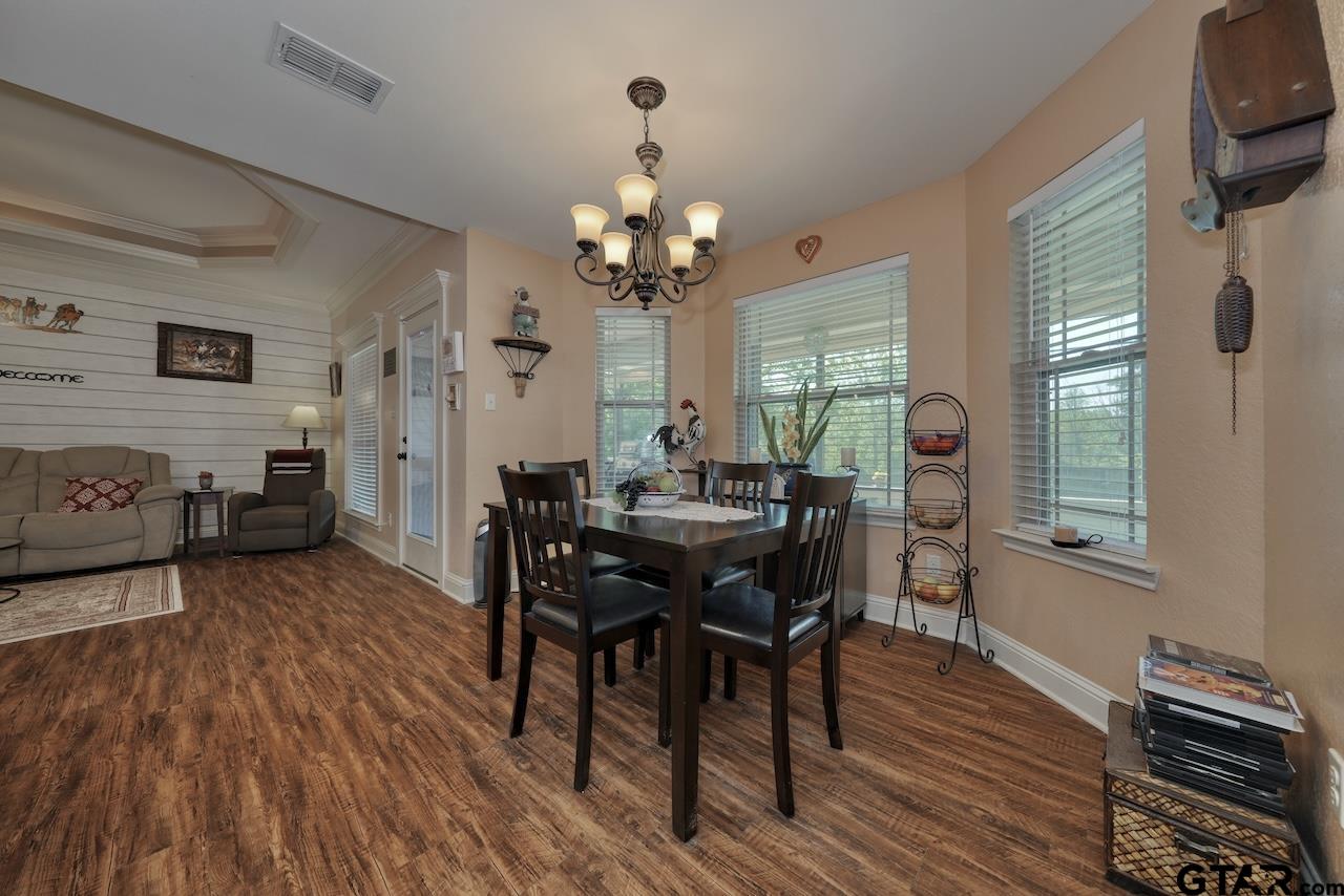 412 Elm Lane Lindale, TX 75771 - Photo 12 of 48 a view of a a dining room with furniture window and wooden floor