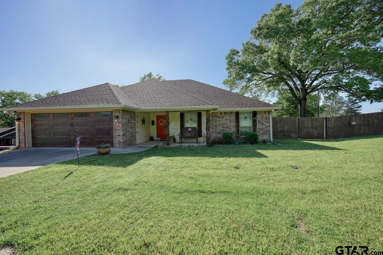 412 Elm Lane Lindale, TX 75771 - Photo 2 of 48 a front view of a house with a garden