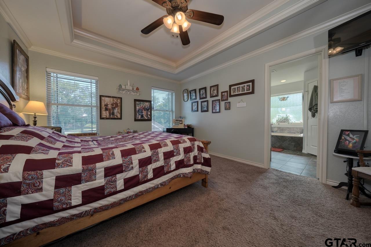 412 Elm Lane Lindale, TX 75771 - Photo 23 of 48 a bedroom with a bed dresser and a window