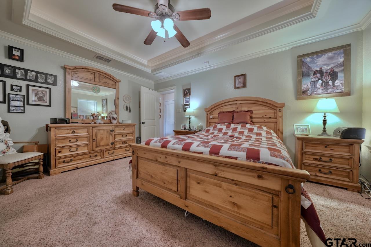 412 Elm Lane Lindale, TX 75771 - Photo 25 of 48 a bedroom with a bed and dresser
