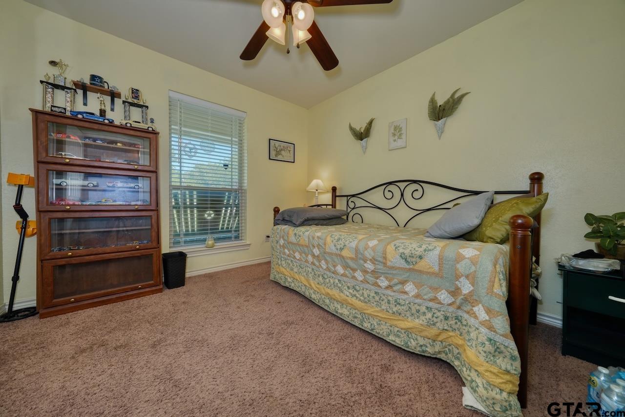 412 Elm Lane Lindale, TX 75771 - Photo 29 of 48 a bedroom with a bed and a night stand