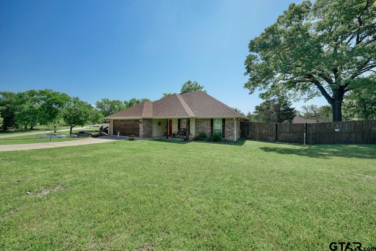 412 Elm Lane Lindale, TX 75771 - Photo 3 of 48 a front view of a house with garden