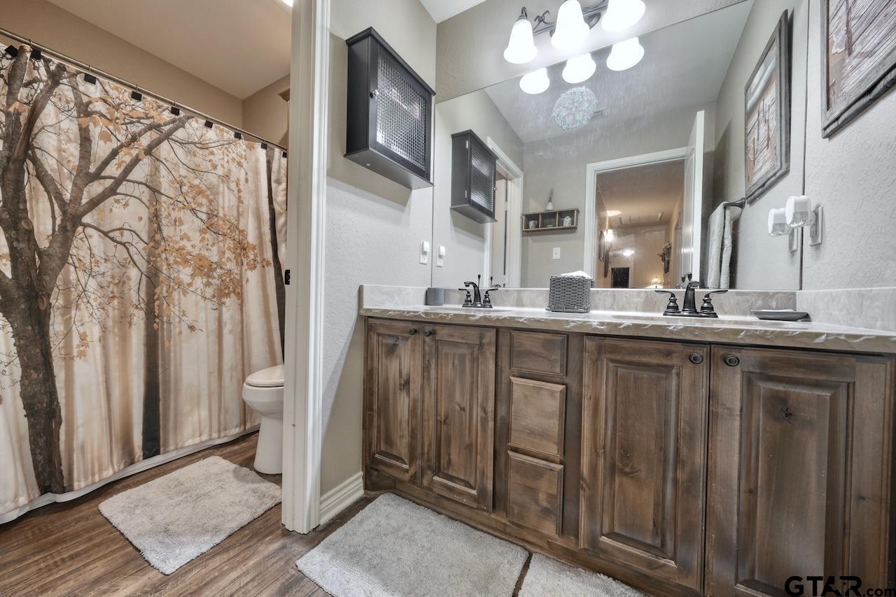 412 Elm Lane Lindale, TX 75771 - Photo 32 of 48 a bathroom with a double vanity sink and a mirror