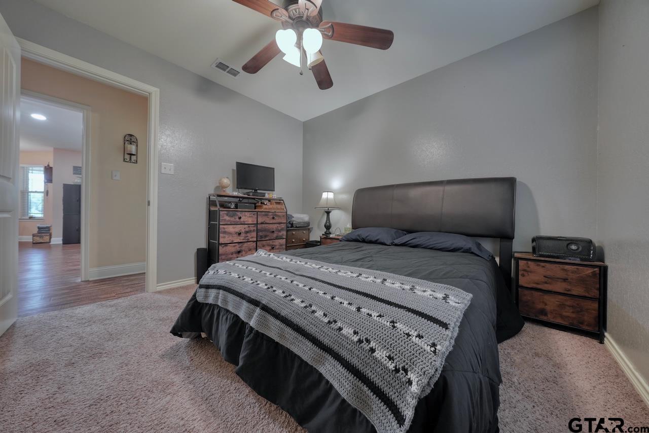 412 Elm Lane Lindale, TX 75771 - Photo 34 of 48 a bedroom with a bed and a tv