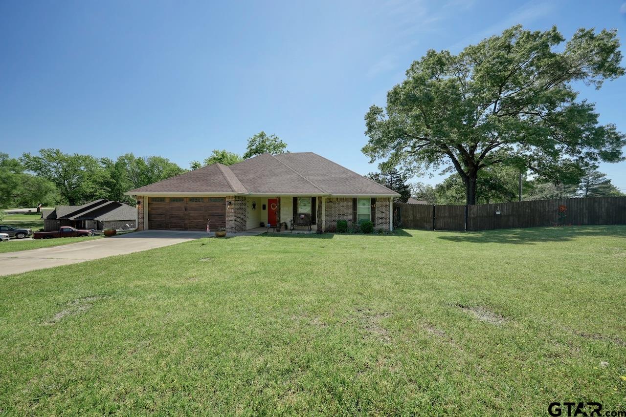 412 Elm Lane Lindale, TX 75771 - Photo 4 of 48 a front view of a house with garden