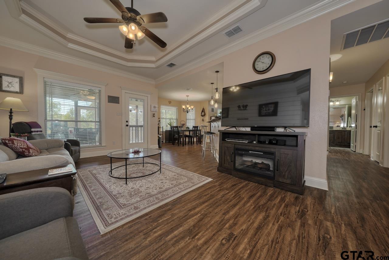 412 Elm Lane Lindale, TX 75771 - Photo 7 of 48 a living room with furniture a fireplace and a flat screen tv