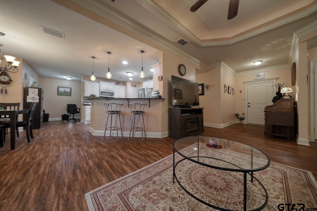 412 Elm Lane Lindale, TX 75771 - Photo 10 of 48 a room with stainless steel appliances kitchen island granite countertop a table chairs and a refrigerator