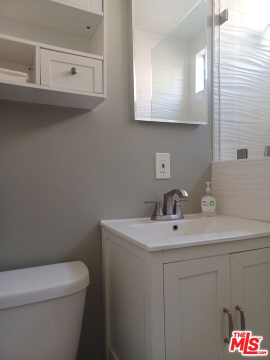 1427 17th Street Santa Monica, CA 90404 - Photo 13 of 13 a bathroom with a sink a toilet and mirror