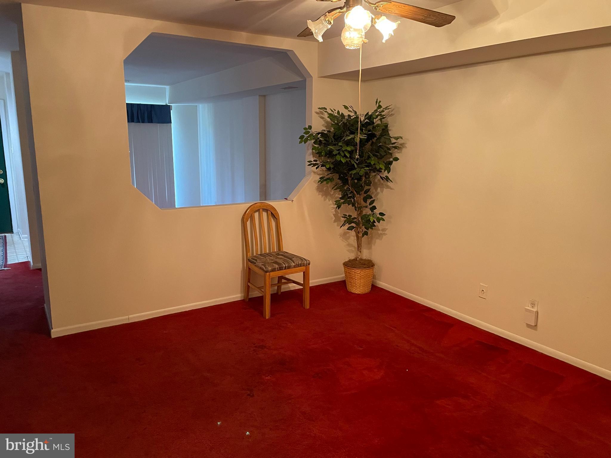 3156 Apple Road Northeast, Unit 18 Washington, DC 20018 - Photo 3 of 16 a view of a room with a potted plant and a chandelier fan