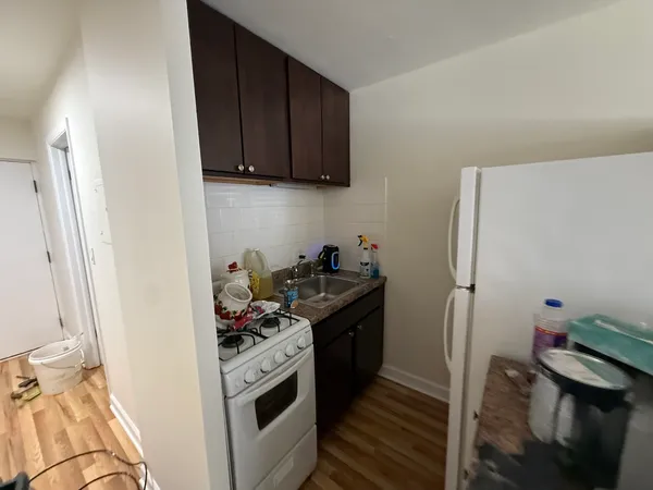 a kitchen with a refrigerator and a stove