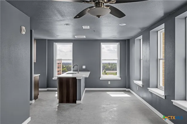 a view of a room with a window and chandelier