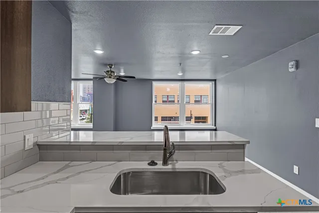 a kitchen with a sink and a refrigerator