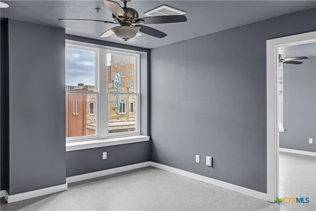 a view of an empty room with a window