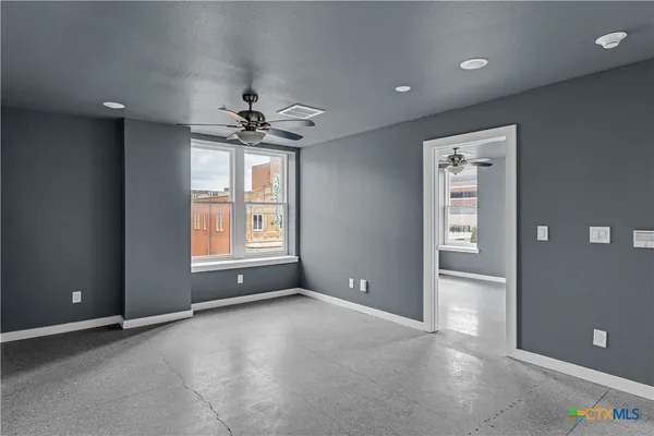 a view of an empty room with a window