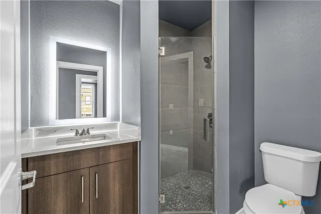 a bathroom with a sink toilet and shower