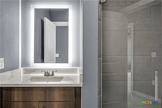a bathroom with a sink and a mirror