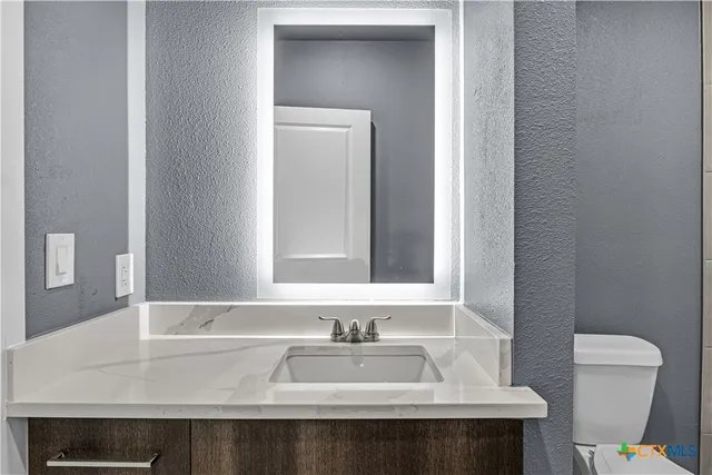 a bathroom with a sink and a toilet