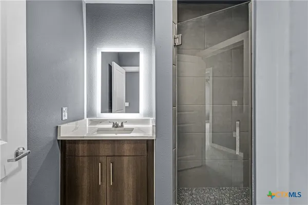 a bathroom with a sink and mirror