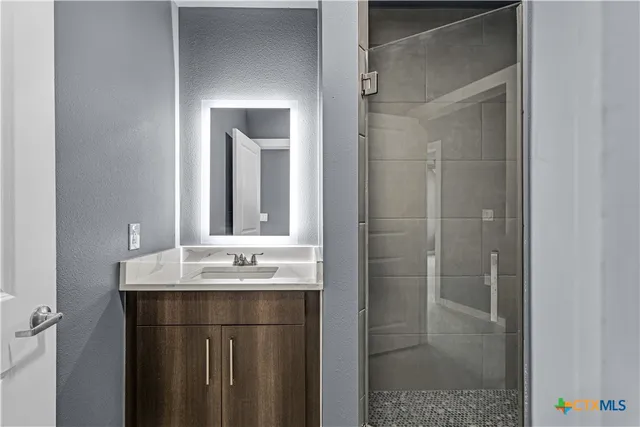 a bathroom with a sink and mirror