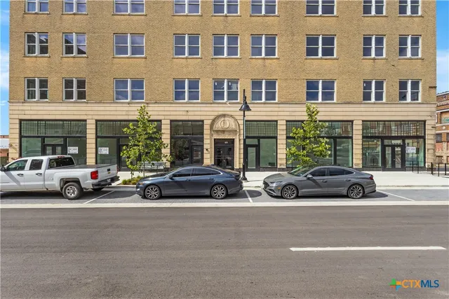 a view of a car parked in front of a building