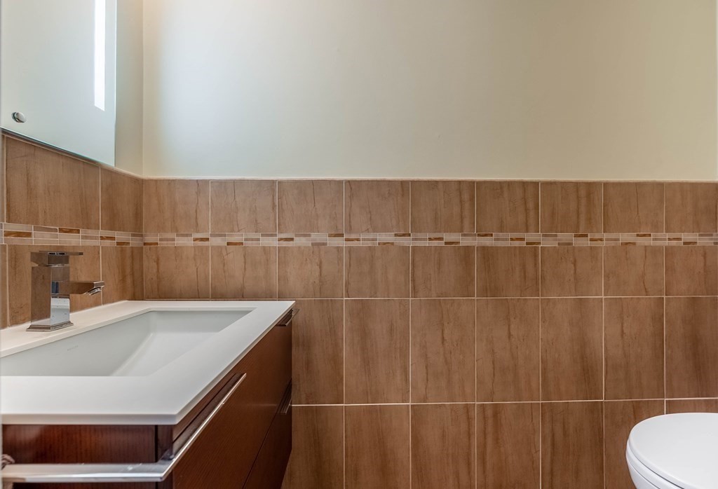 101 Mill Pond, Unit 101 North Andover, MA 01845 - Photo 12 of 27 a bathroom with a sink a toilet and a mirror
