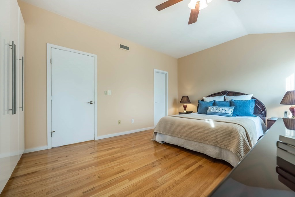 101 Mill Pond, Unit 101 North Andover, MA 01845 - Photo 14 of 27 a bedroom with a bed and a chandelier