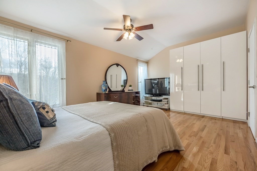 101 Mill Pond, Unit 101 North Andover, MA 01845 - Photo 15 of 27 a bedroom with a large bed and a tv