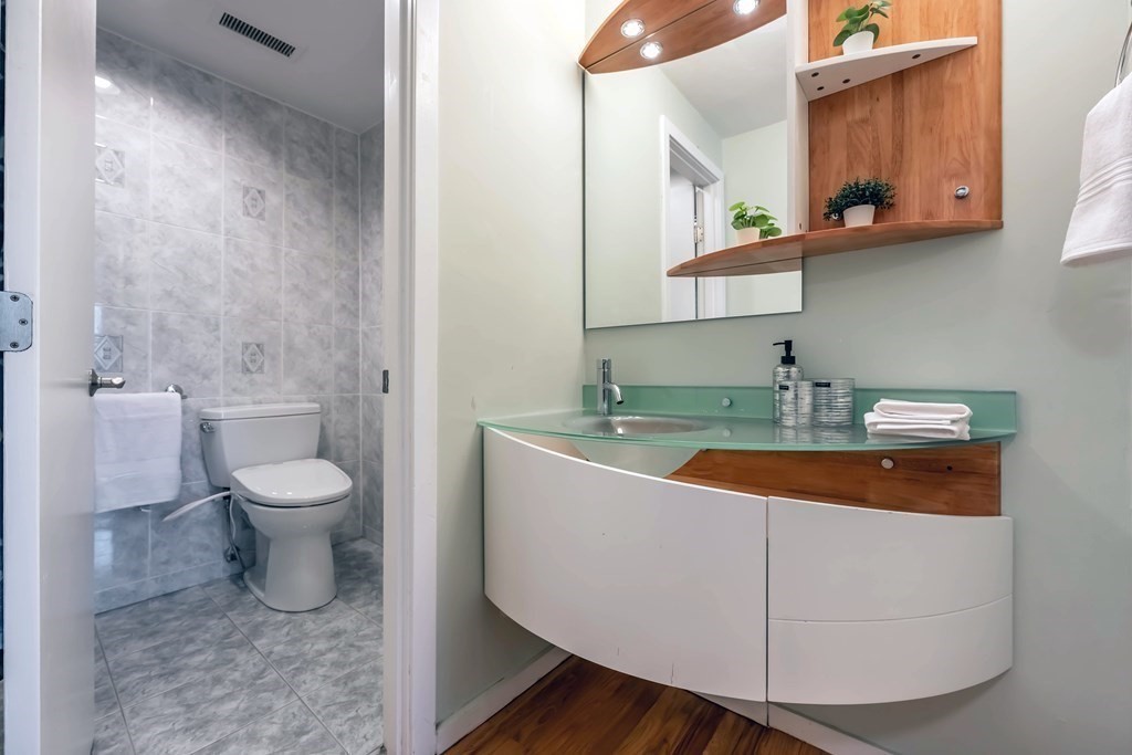 101 Mill Pond, Unit 101 North Andover, MA 01845 - Photo 16 of 27 a bathroom with a toilet sink and mirror
