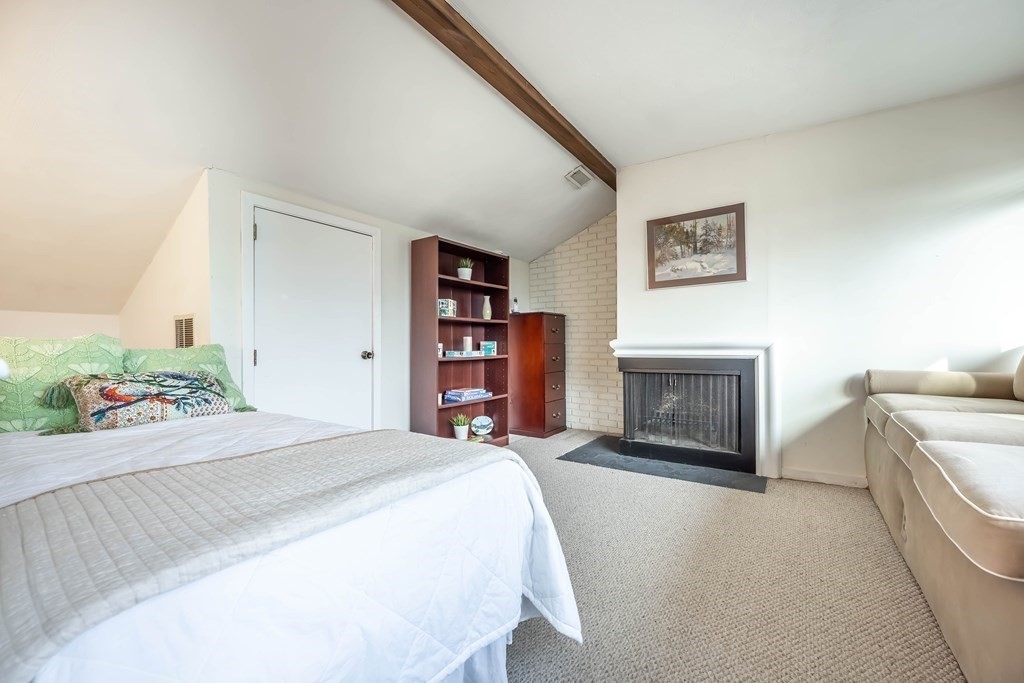 101 Mill Pond, Unit 101 North Andover, MA 01845 - Photo 20 of 27 a bedroom with a bed and a fireplace