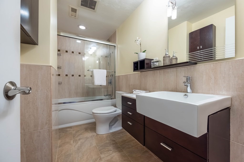 101 Mill Pond, Unit 101 North Andover, MA 01845 - Photo 22 of 27 a bathroom with a sink a toilet and shower