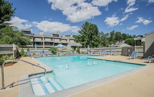 101 Mill Pond, Unit 101 North Andover, MA 01845 - Photo 26 of 27 a view of a swimming pool with a lawn chairs under an umbrella
