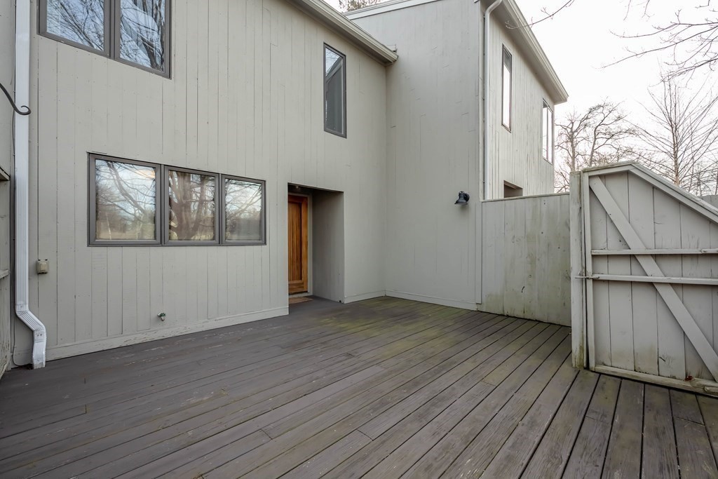 101 Mill Pond, Unit 101 North Andover, MA 01845 - Photo 3 of 27 a view of an empty room with wooden floor and a window