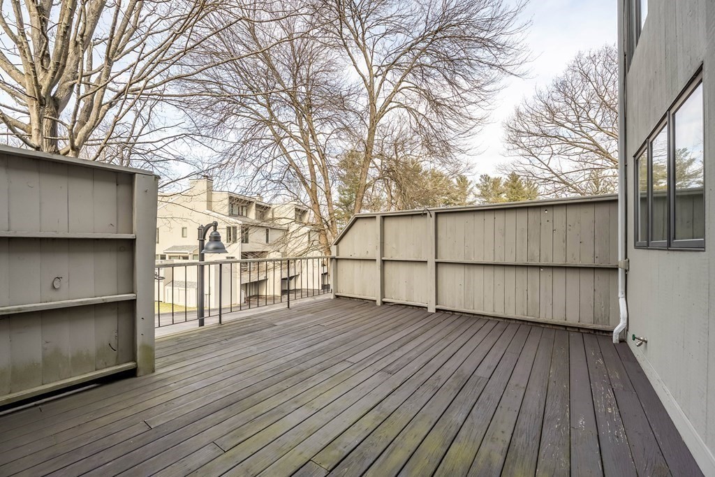 101 Mill Pond, Unit 101 North Andover, MA 01845 - Photo 4 of 27 a view of a backyard with wooden floor and fence