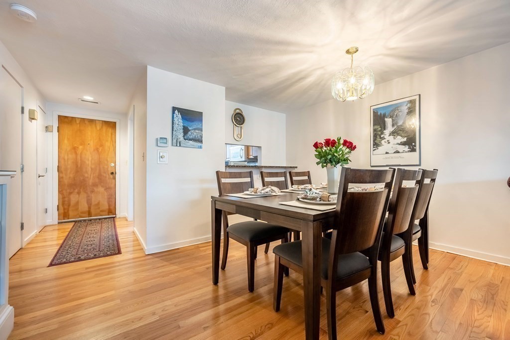 101 Mill Pond, Unit 101 North Andover, MA 01845 - Photo 7 of 27 a view of a dining room with furniture and wooden floor
