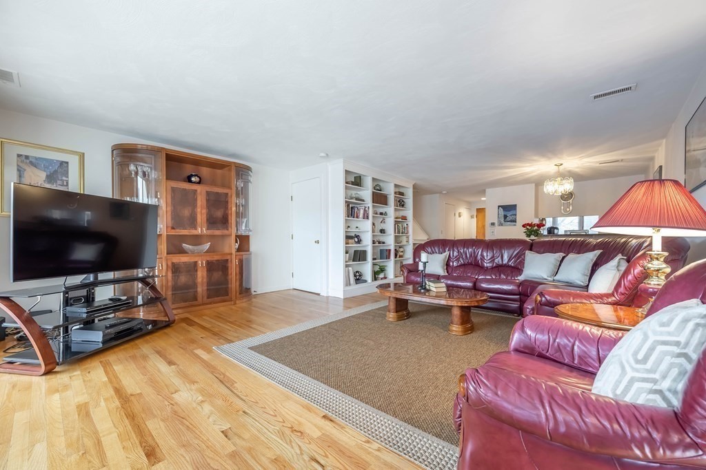 101 Mill Pond, Unit 101 North Andover, MA 01845 - Photo 9 of 27 a living room with furniture and a flat screen tv