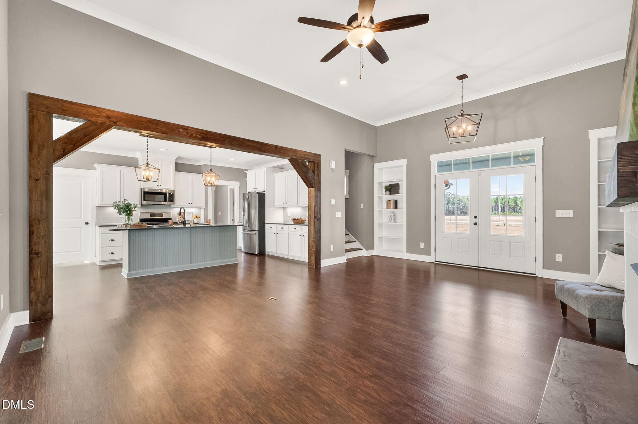 325 Old Stancil Road Kenly, NC 27542 - Photo 11 of 54 a view of an empty room with wooden floor and a kitchen