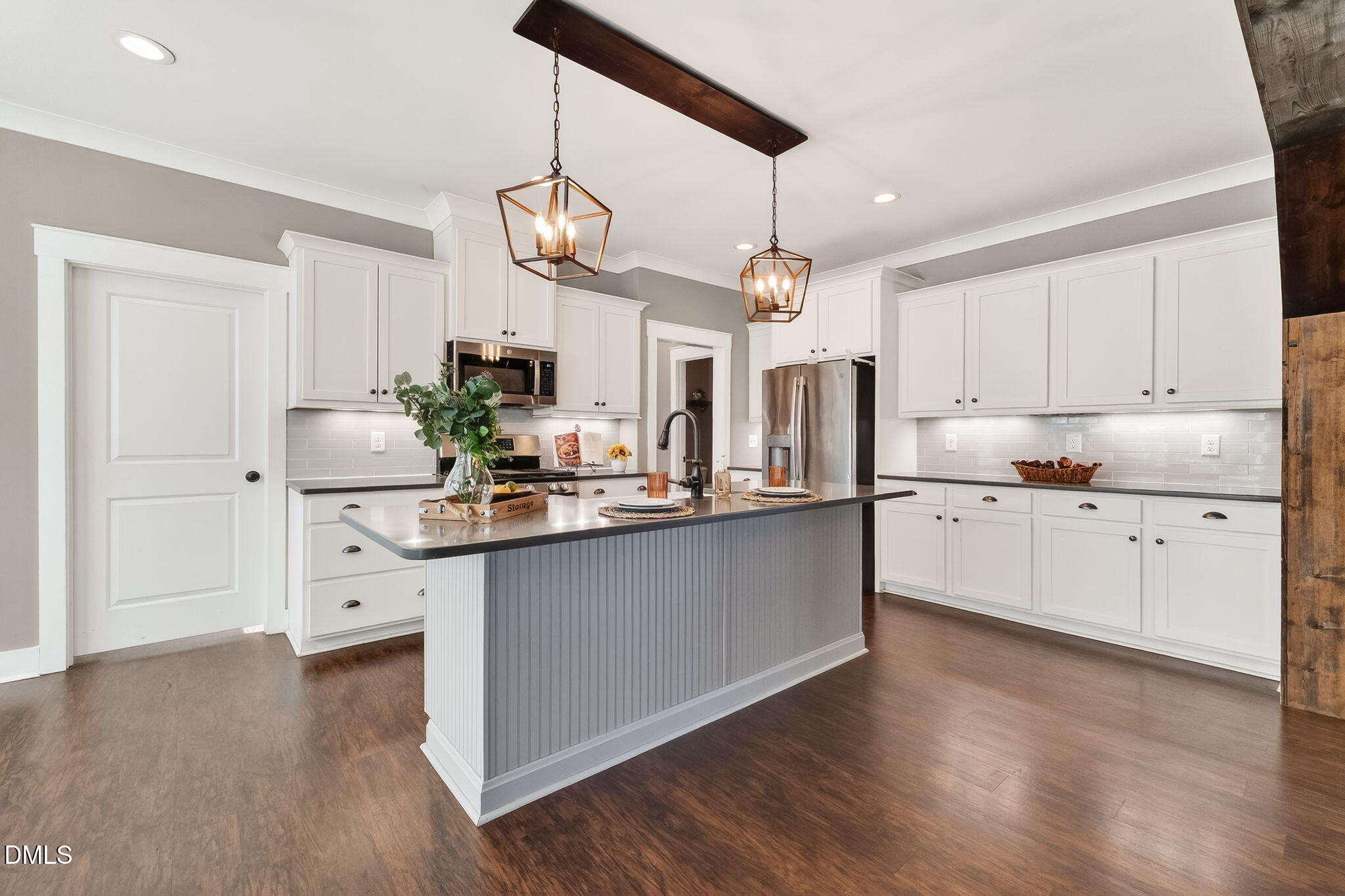 325 Old Stancil Road Kenly, NC 27542 - Photo 12 of 54 a kitchen with stainless steel appliances granite countertop a white cabinets and wooden floor