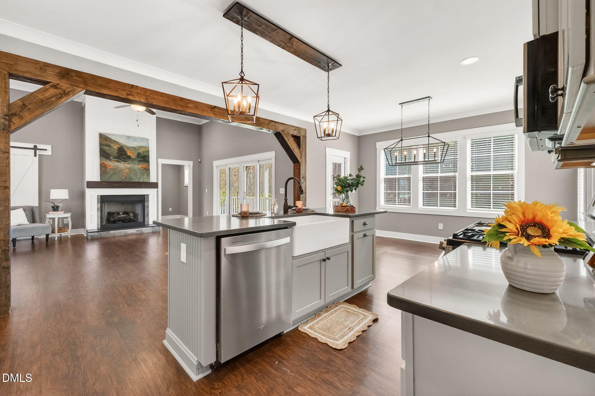 325 Old Stancil Road Kenly, NC 27542 - Photo 15 of 54 a kitchen with stainless steel appliances granite countertop a stove a sink dishwasher and a dining table with wooden floor